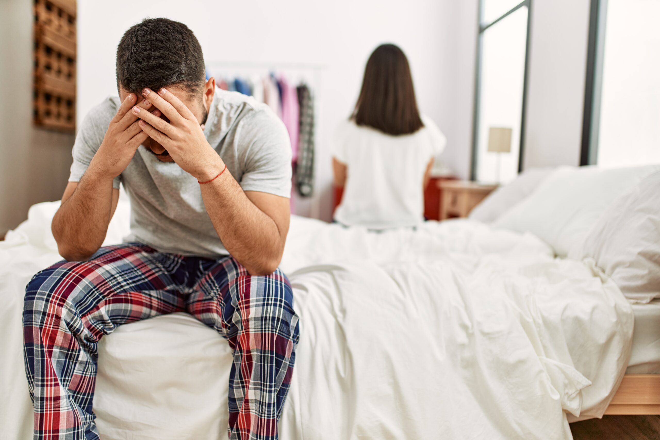 Young Latin Couple Trouble Sitting Bed With Hands Head Scaled